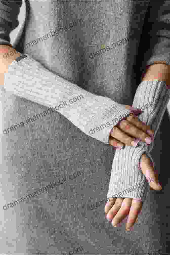 A Pair Of Knitted Wrist Warmers In A Soft Gray Yarn Easy To Make Wrist Warmers Hat And Neck Warmer Knitting Pattern